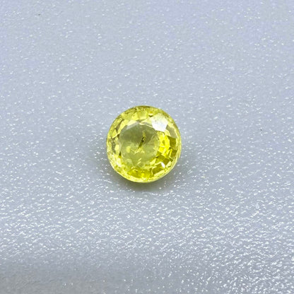 Round light lemon yellow sapphire from Bangkaja, Thailand with delicate bright color and clean natural brilliance.