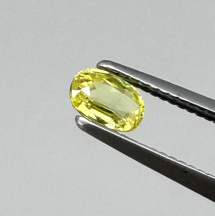 Oval light lemon yellow sapphire from Bangkaja, Thailand with fresh bright color and natural brilliance.