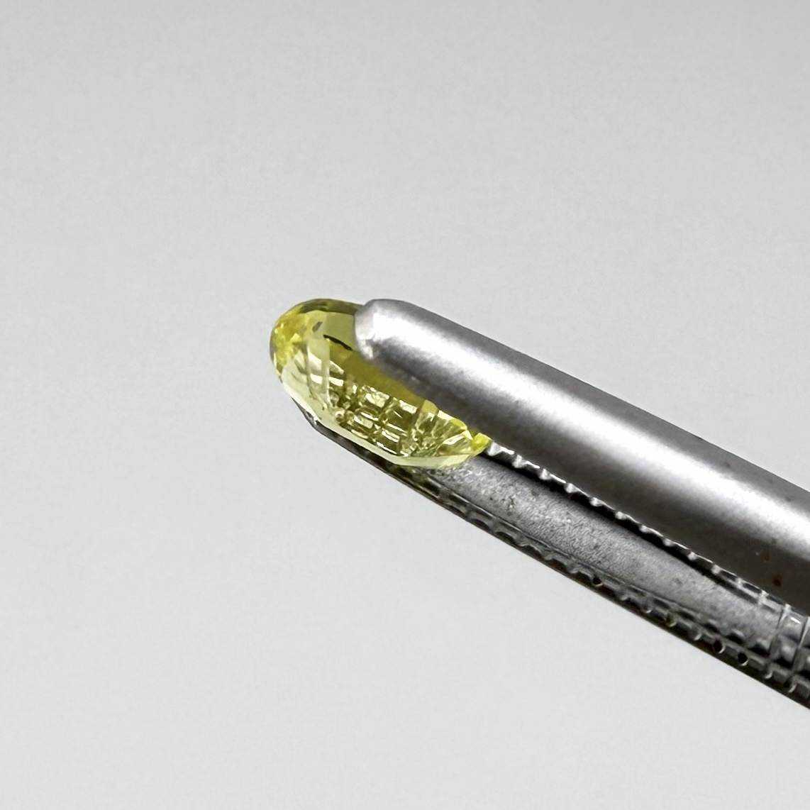 Oval light lemon yellow sapphire from Bangkaja, Thailand with fresh bright color and natural brilliance.