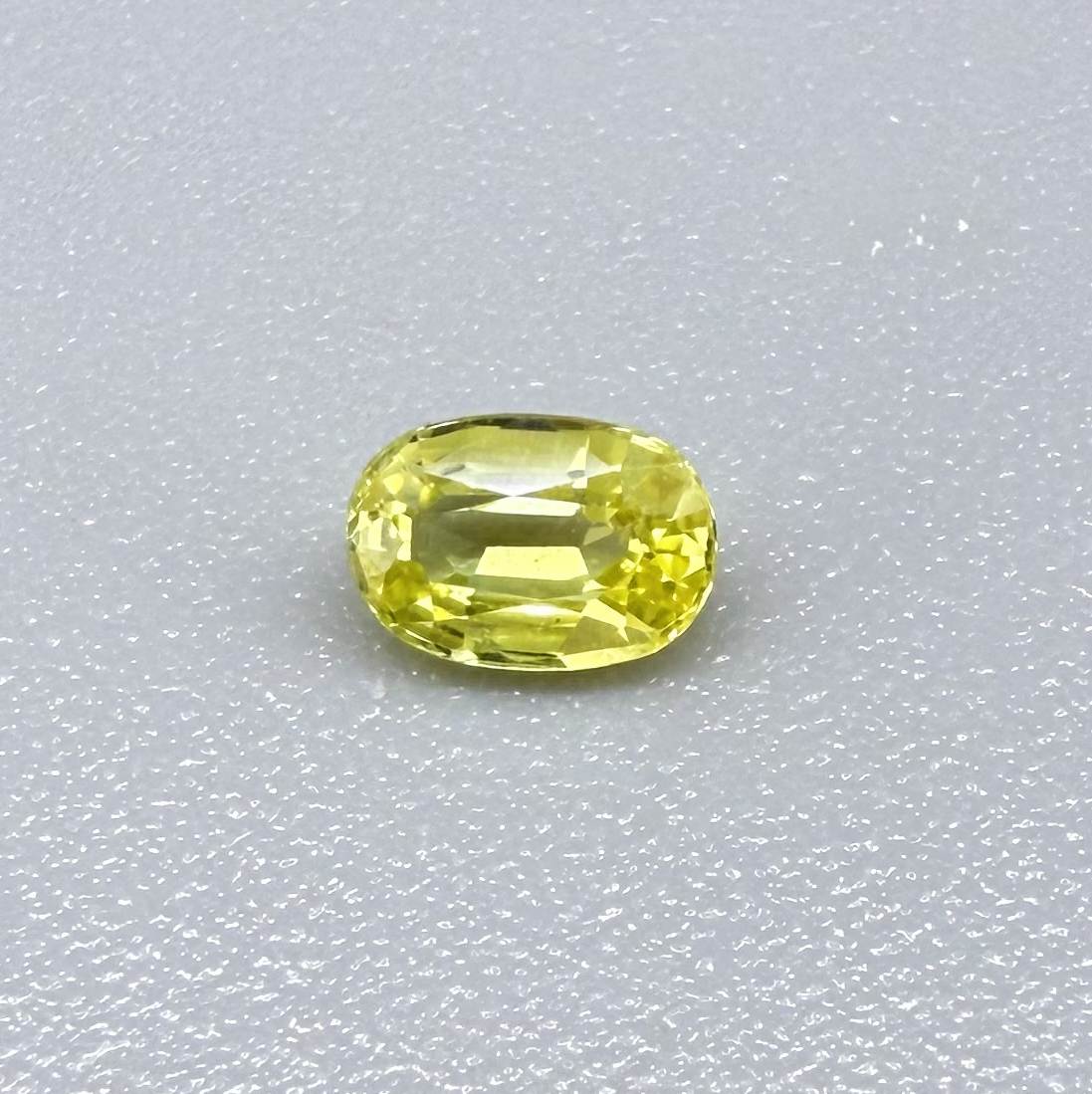 Oval light lemon yellow sapphire from Bangkaja, Thailand with fresh bright color and natural brilliance.