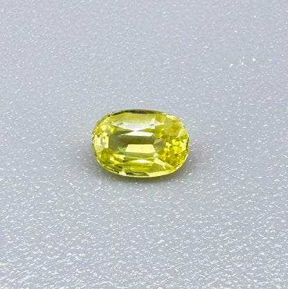 Oval light lemon yellow sapphire from Bangkaja, Thailand with fresh bright color and natural brilliance.