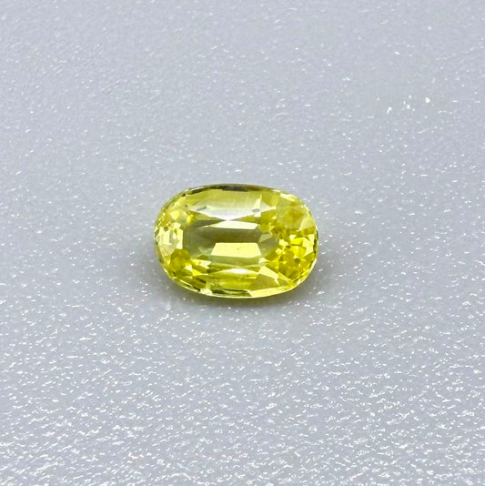 Oval light lemon yellow sapphire from Bangkaja, Thailand with fresh bright color and natural brilliance.