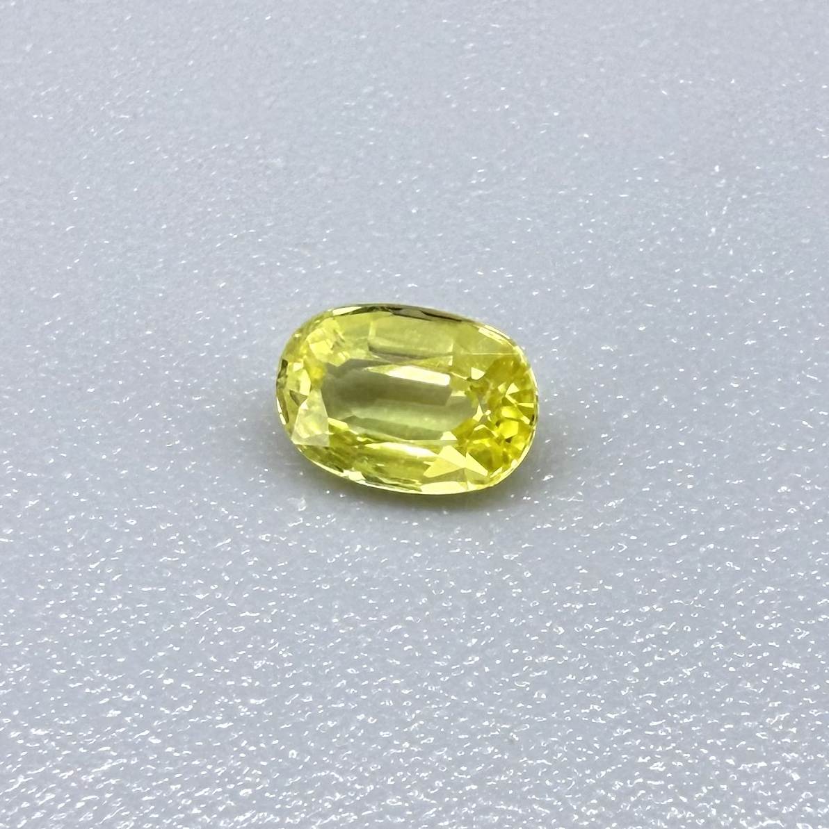 Oval light lemon yellow sapphire from Bangkaja, Thailand with fresh bright color and natural brilliance.