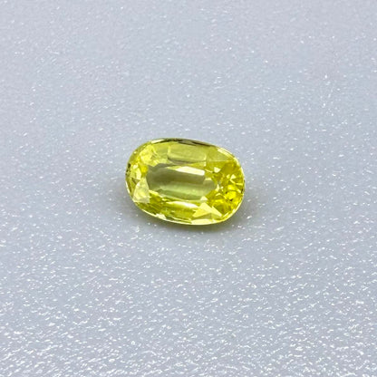 Oval light lemon yellow sapphire from Bangkaja, Thailand with fresh bright color and natural brilliance.
