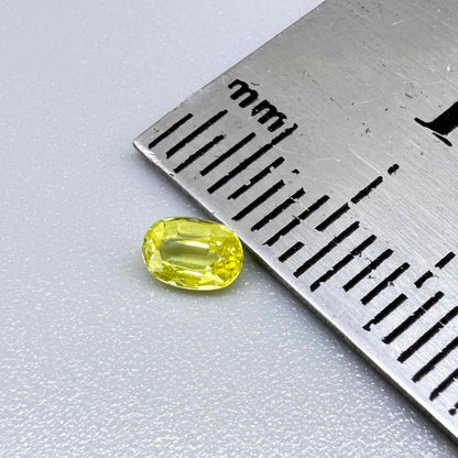 Oval light lemon yellow sapphire from Bangkaja, Thailand with fresh bright color and natural brilliance.