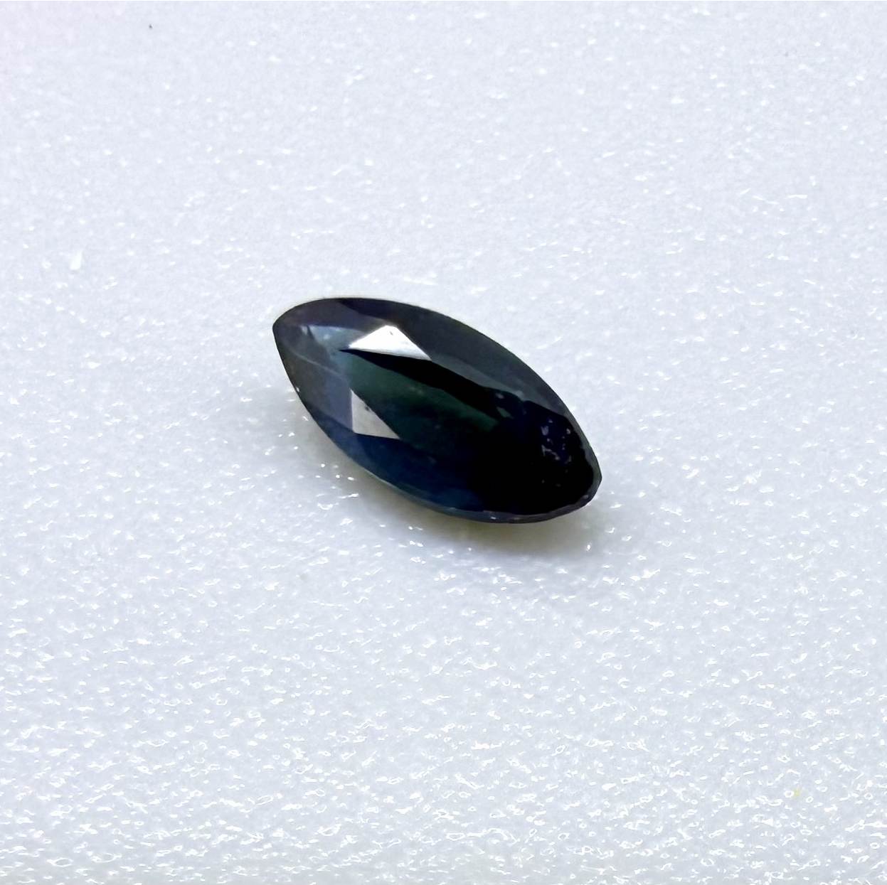 Marquise dark teal blue sapphire from Bangkaja, Thailand with deep blue-green tone and natural color zoning.