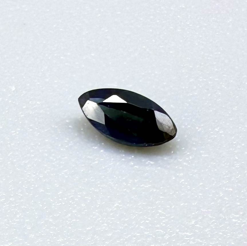 Marquise dark teal blue sapphire from Bangkaja, Thailand with deep blue-green tone and natural color zoning.