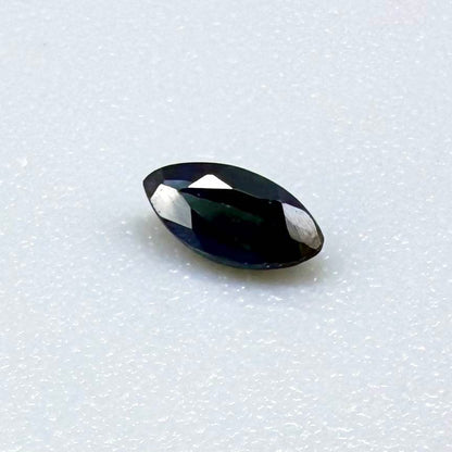 Marquise dark teal blue sapphire from Bangkaja, Thailand with deep blue-green tone and natural color zoning.