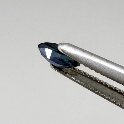 Marquise dark teal blue sapphire from Bangkaja, Thailand with deep blue-green tone and natural color zoning.