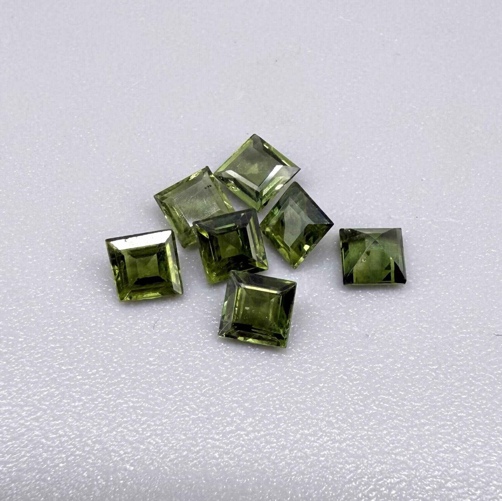 Green sapphire parcel in square cuts from Bangkaja, Thailand showing olive to yellowish-green tones with natural brilliance.
