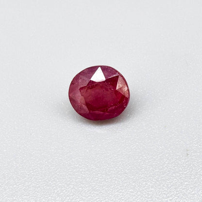 Oval reddish pink ruby from Mozambique with soft rosé tone, visible natural inclusions and gentle semi-transparent appearance.