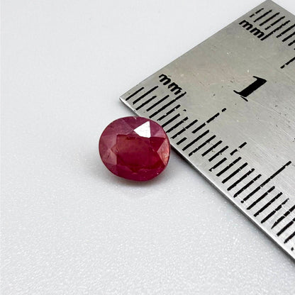 Oval reddish pink ruby from Mozambique with soft rosé tone, visible natural inclusions and gentle semi-transparent appearance.
