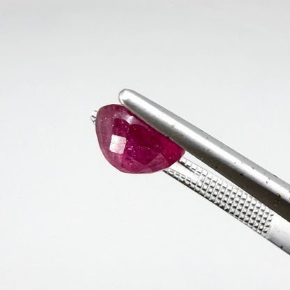 Oval reddish pink ruby from Mozambique with soft rosé tone, visible natural inclusions and gentle semi-transparent appearance.