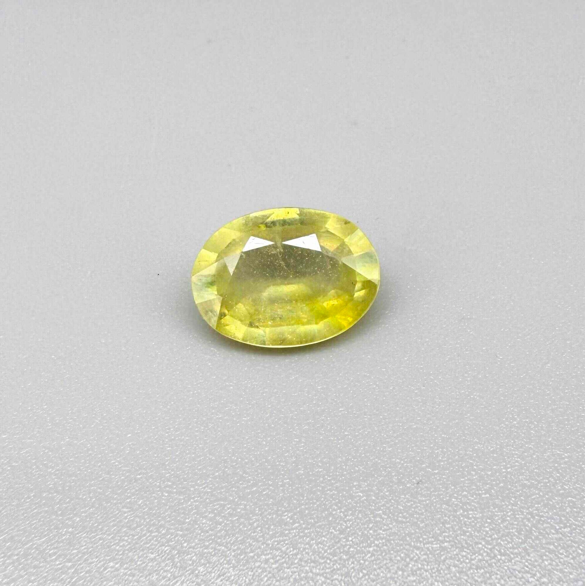 Oval yellow sapphire from Africa, 4ct, with bright lemon-yellow color, slight natural inclusions and a transparent to lightly silky appearance.