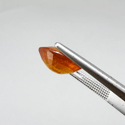 Oval orange sapphire from Africa, 4.43ct, with deep burnt orange color, visible natural inclusions and a transparent to slightly silky appearance.