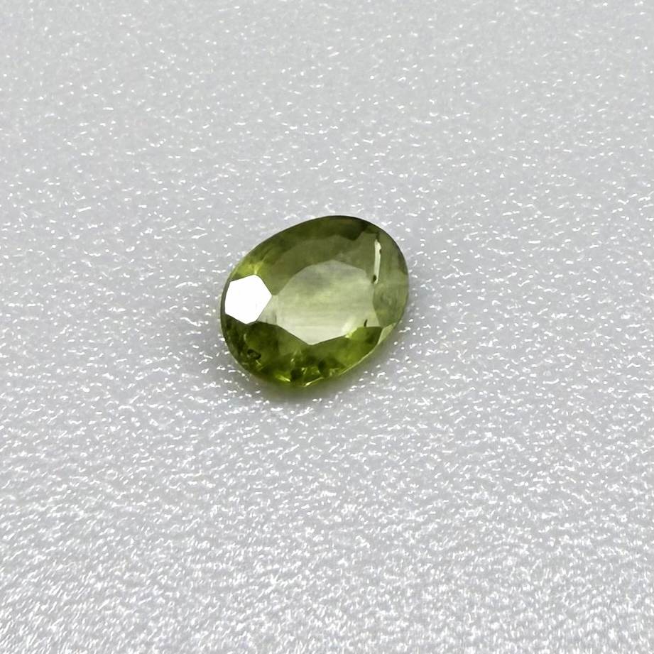 Oval green sapphire from Thailand, 0.29ct, unheated, with fresh olive-green color, eye-clean clarity and a transparent appearance.