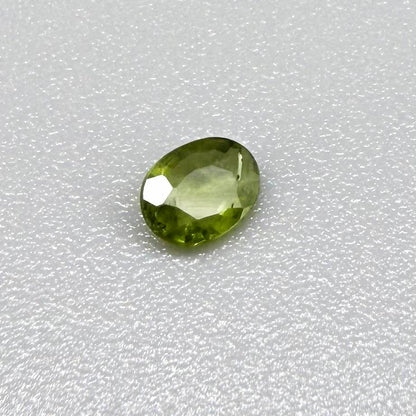 Oval green sapphire from Thailand, 0.29ct, unheated, with fresh olive-green color, eye-clean clarity and a transparent appearance.
