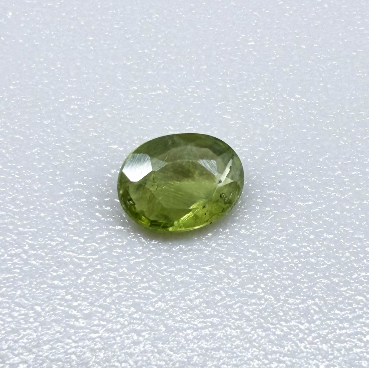 Oval green sapphire from Thailand, 0.29ct, unheated, with fresh olive-green color, eye-clean clarity and a transparent appearance.