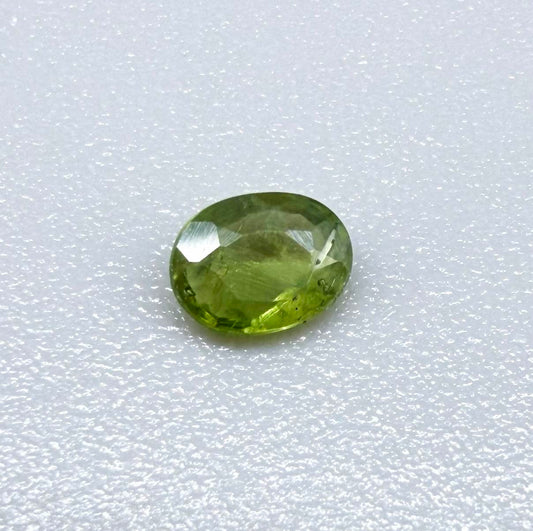 Oval green sapphire from Thailand, 0.29ct, unheated, with fresh olive-green color, eye-clean clarity and a transparent appearance.