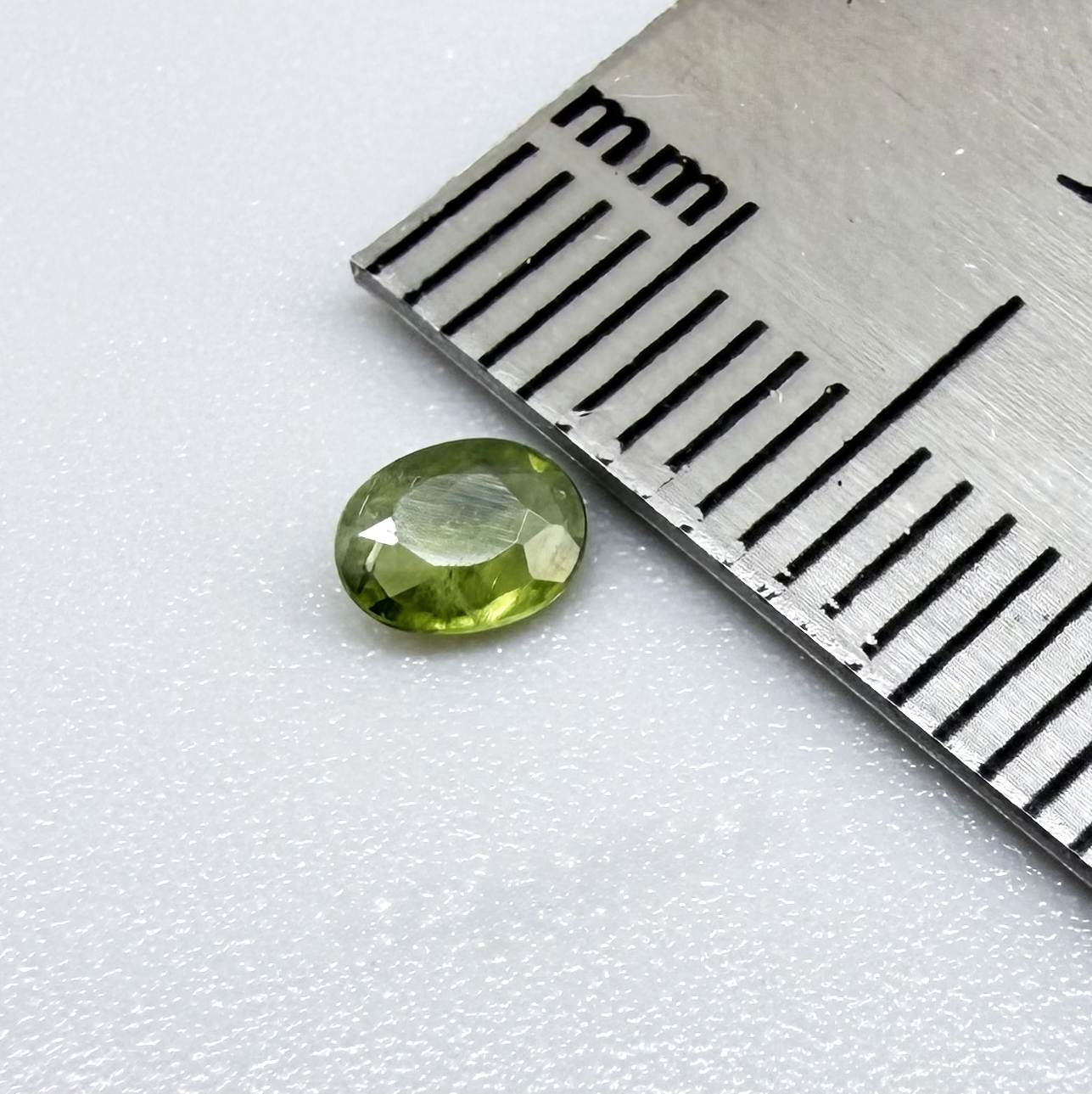 Oval green sapphire from Thailand, 0.29ct, unheated, with fresh olive-green color, eye-clean clarity and a transparent appearance.
