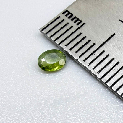Oval green sapphire from Thailand, 0.29ct, unheated, with fresh olive-green color, eye-clean clarity and a transparent appearance.
