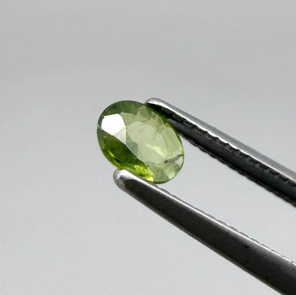 Oval green sapphire from Thailand, 0.29ct, unheated, with fresh olive-green color, eye-clean clarity and a transparent appearance.
