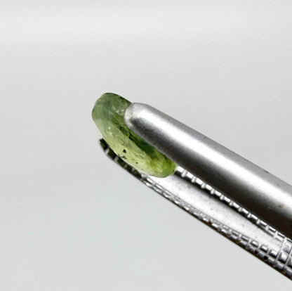 Oval light green sapphire from Thailand, 0.42ct, unheated, with soft pistachio-green color, visible natural inclusions and a transparent to slightly silky appearance.