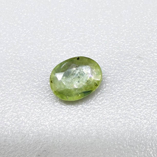 Oval light green sapphire from Thailand, 0.42ct, unheated, with soft pistachio-green color, visible natural inclusions and a transparent to slightly silky appearance.