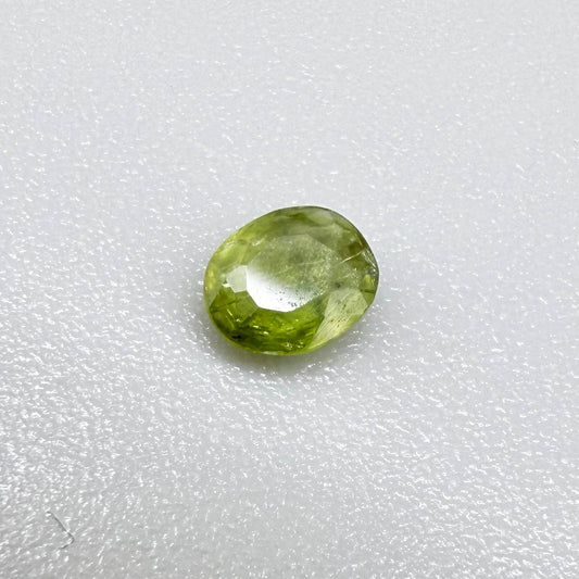 Oval light green sapphire from Thailand, 0.31ct, unheated, with fresh yellow-green color, visible natural inclusions and a transparent to slightly silky appearance.
