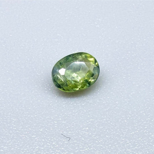 Oval green sapphire from Thailand, 0.35ct, unheated, with fresh green hues, visible natural inclusions and a transparent to slightly silky appearance.