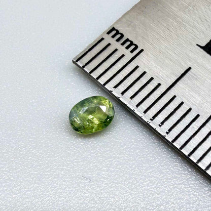 Oval green sapphire from Thailand, 0.35ct, unheated, with fresh green hues, visible natural inclusions and a transparent to slightly silky appearance.