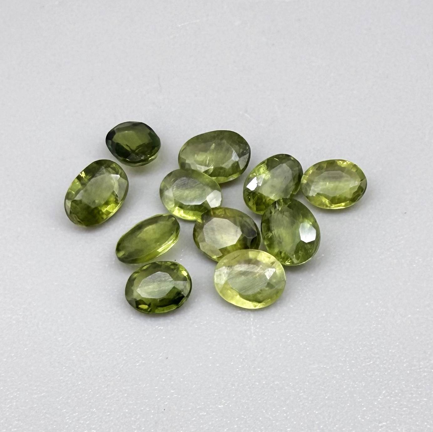Lot of oval green sapphires from Thailand, 3.02ct total weight, unheated, with fresh to olive-green tones, mostly eye-clean to lightly included and transparent appearance.