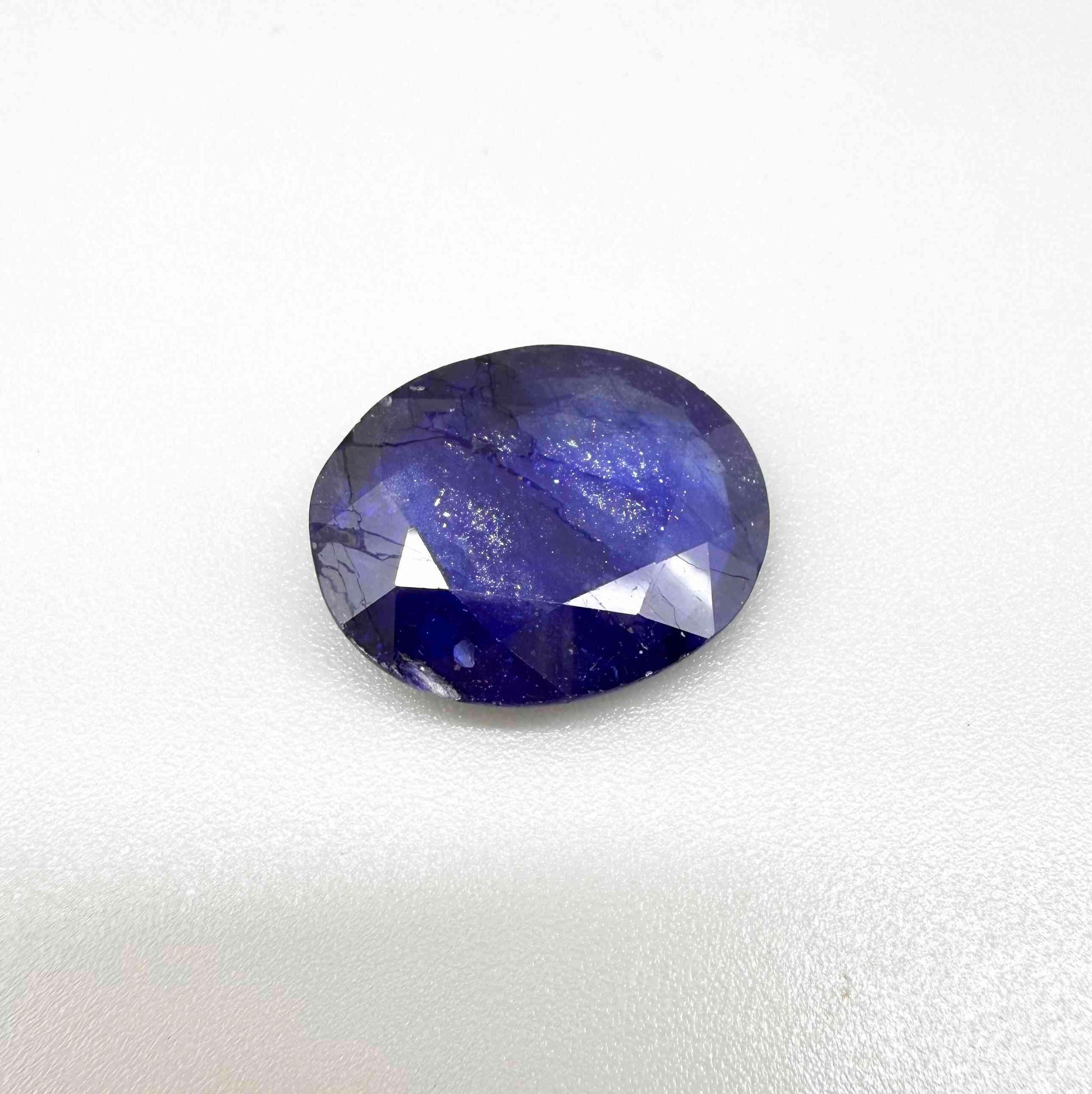 Large enhanced deep blue sapphire 17.2 ct with intense vivid blue color and faceted oval cut statement appearance