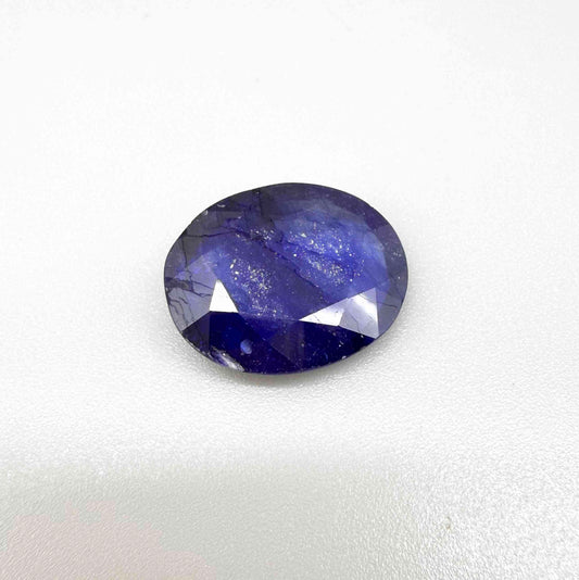 Large enhanced deep blue sapphire 17.2 ct with intense vivid blue color and faceted oval cut statement appearance