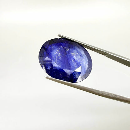 Large enhanced deep blue sapphire 17.2 ct with intense vivid blue color and faceted oval cut statement appearance