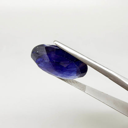 Large enhanced deep blue sapphire 17.2 ct with intense vivid blue color and faceted oval cut statement appearance