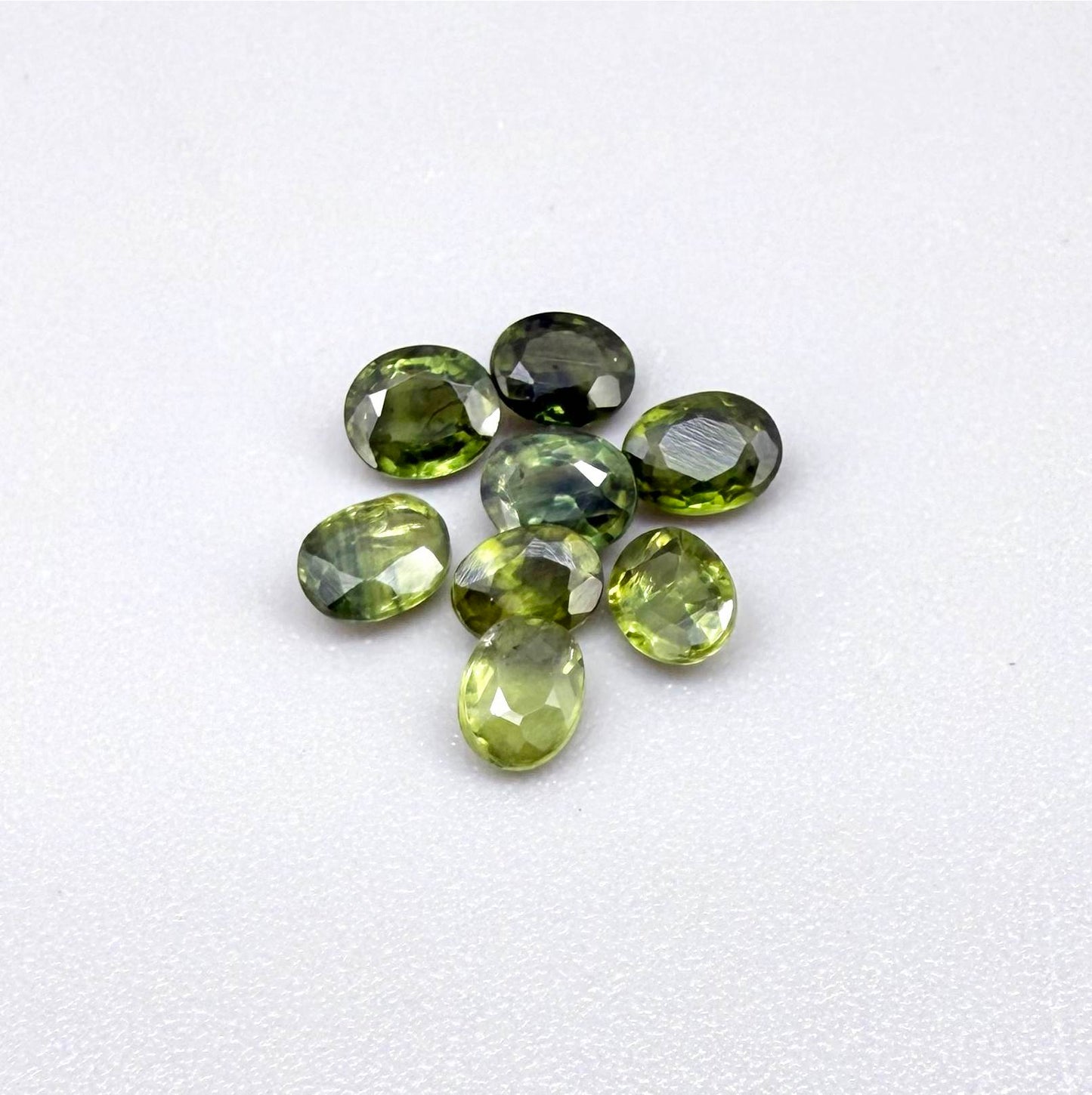 Lot of oval green sapphires from Thailand, 3.02ct total weight, unheated, with fresh to olive-green tones, mostly eye-clean to lightly included and transparent appearance.