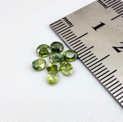 Lot of oval green sapphires from Thailand, 3.02ct total weight, unheated, with fresh to olive-green tones, mostly eye-clean to lightly included and transparent appearance.