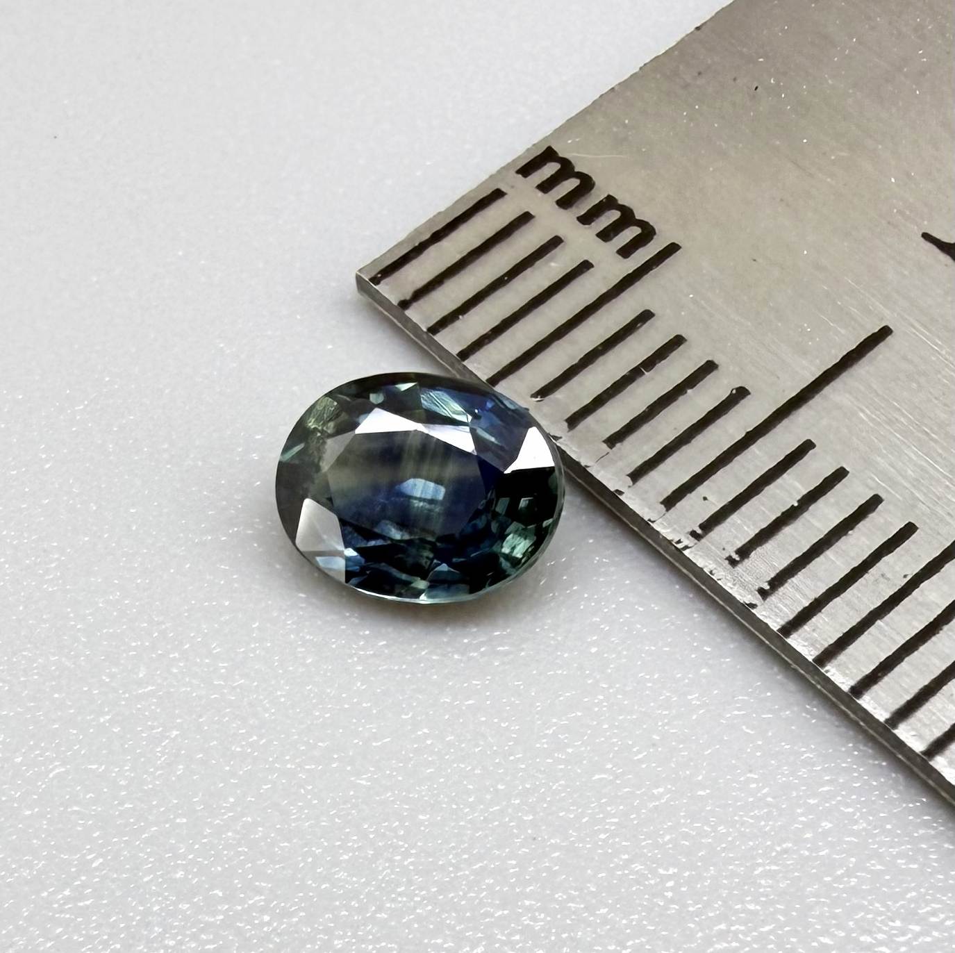 Heated blue sapphire from Mambila Nigeria oval cut 0.85 ct with vivid teal-blue flashes and brilliant natural luster