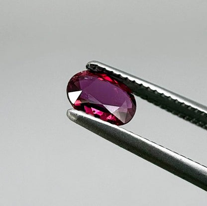 Heated ruby from Bo Rai Thailand, oval cut, 0.50 ct with vivid purplish-red color and natural brilliance.