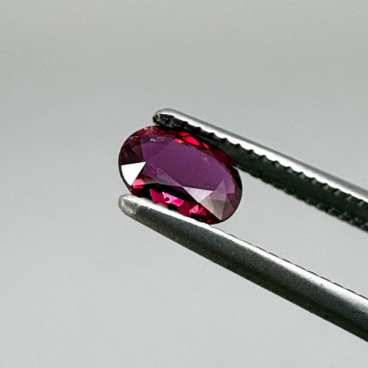 Heated ruby from Bo Rai Thailand, oval cut, 0.50 ct with vivid purplish-red color and natural brilliance.