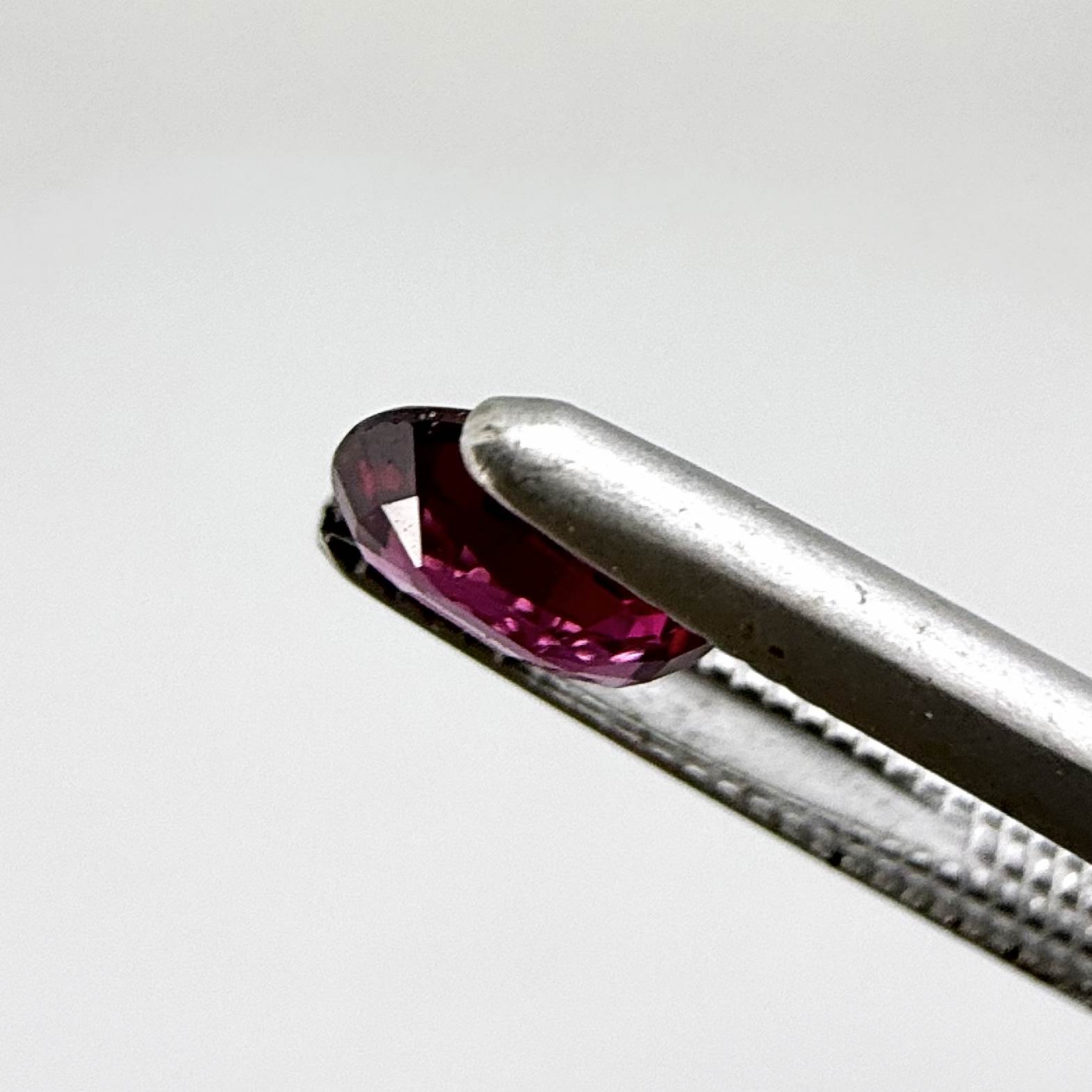 Heated ruby from Bo Rai Thailand, oval cut, 0.50 ct with vivid purplish-red color and natural brilliance.
