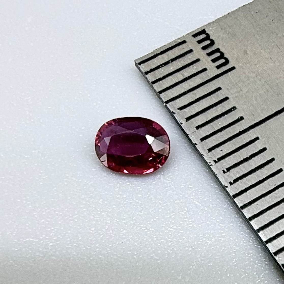 Heated ruby from Bo Rai Thailand, oval cut, 0.50 ct with vivid purplish-red color and natural brilliance.