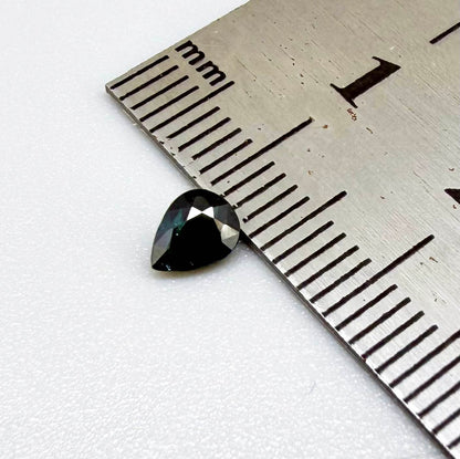 Deep teal blue-green Laos sapphire pear weighing 0.45 ct, heated and eye-clean.
