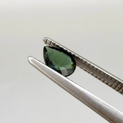 Deep teal blue-green Laos sapphire pear weighing 0.45 ct, heated and eye-clean.
