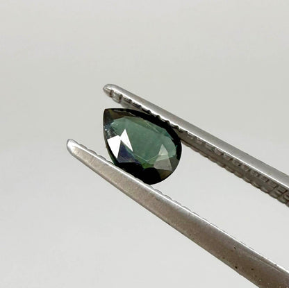 Deep teal blue-green Laos sapphire pear weighing 0.45 ct, heated and eye-clean.