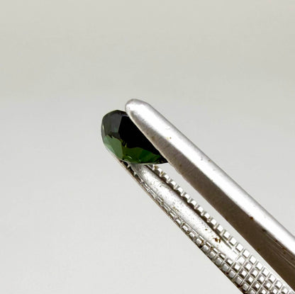 Deep teal blue-green Laos sapphire pear weighing 0.45 ct, heated and eye-clean.