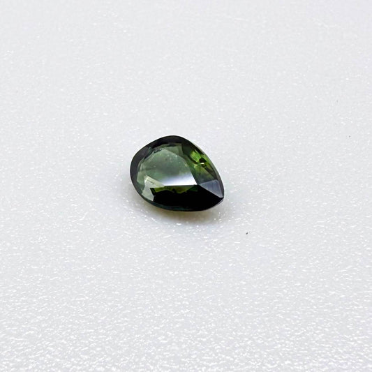 Olive green pear-shaped Laos sapphire weighing 0.39 ct, heated and eye-clean.