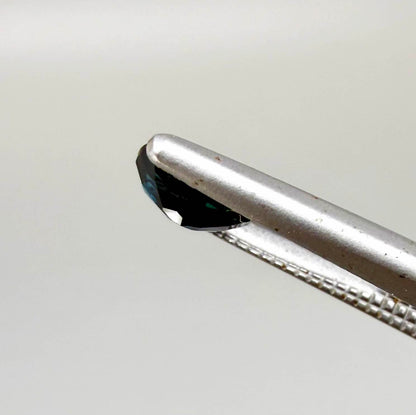 0.57 ct teal blue Laos sapphire in oval cut, heated and eye-clean with vivid blue-green tones.