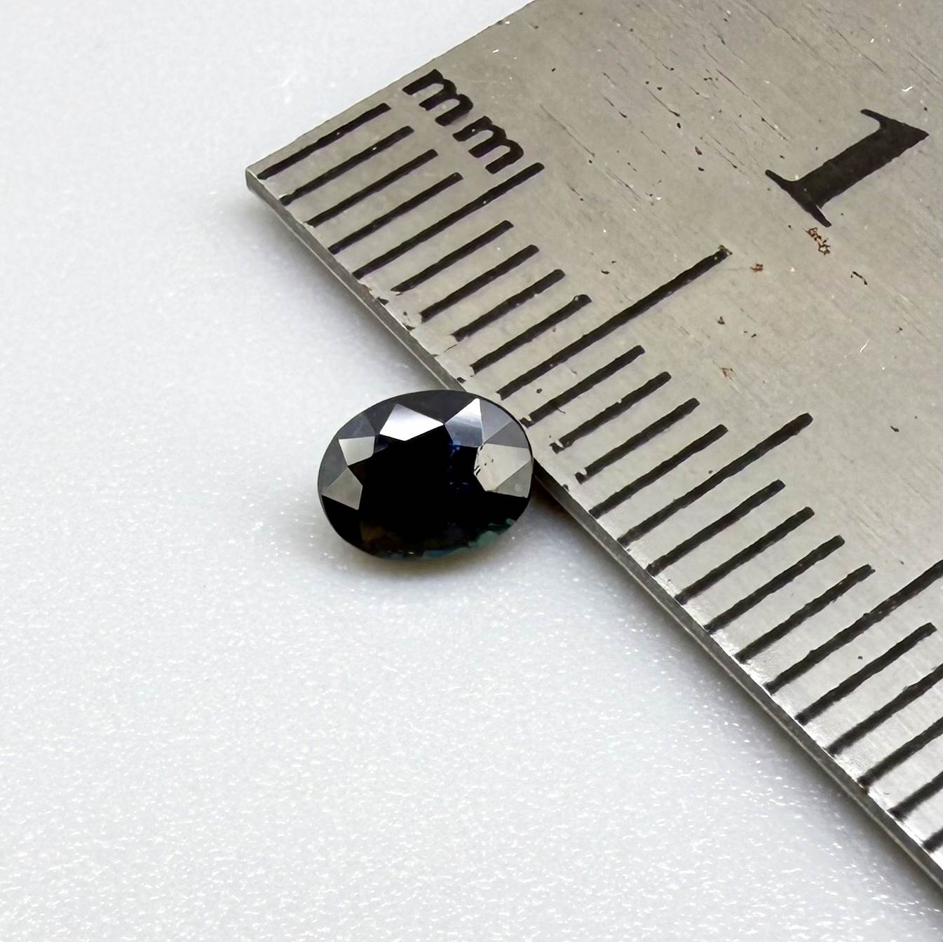 0.56 ct teal Laos sapphire in oval cut, heated and eye-clean with captivating blue-green color.